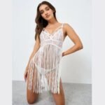 Model posing in white fancy lace nighty dress in pakistan with fringe hem
